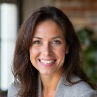 Portrait of Dr. Elara Vance, a certified wellness coach, with a warm, encouraging smile.