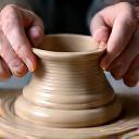 Artisan working on a ceramic piece, representing quality craftsmanship verification