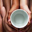 Multiple hands holding a ceramic mug, symbolizing customer feedback integration