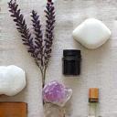 Artistic flat lay of various natural wellness elements like essential oils, herbs, and crystals, arranged aesthetically.